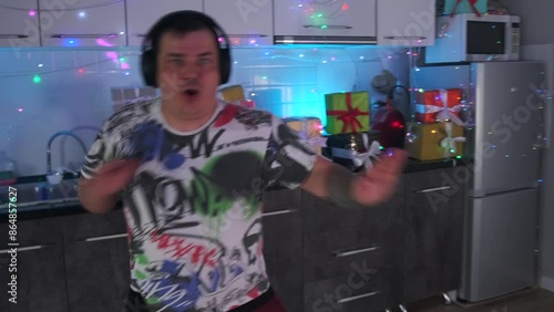 Slow motion relaxed young plump man dancing merrily at a home party celebrating Christmas, Birthday, New Year.