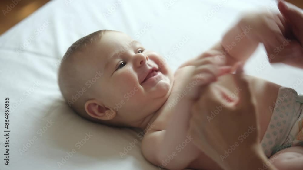 Mother playing in bed with adorable newborn baby boy. Family concept Mother playing in bed with adorable newborn baby boy. Family concept