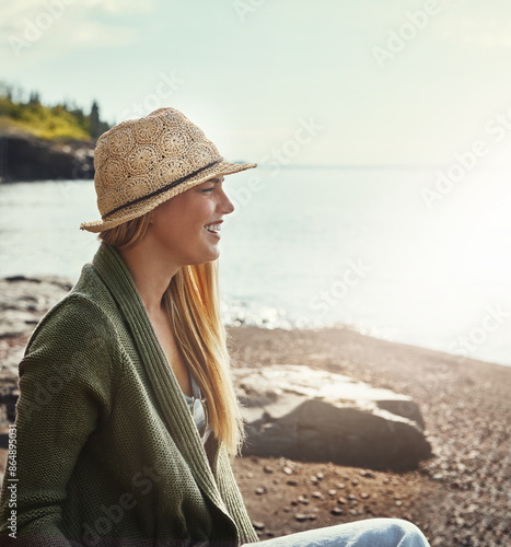 Smile, thinking and woman at beach on holiday, vacation or travel outdoor on island in Greece. Ocean, funny and happy person laugh at sea by water for journey, adventure and tourist on trip in nature