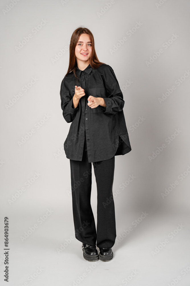 Young Woman Gesturing With Hands In Frame Against Plain Background Young Woman Gesturing With Hands In Frame Against Plain Background