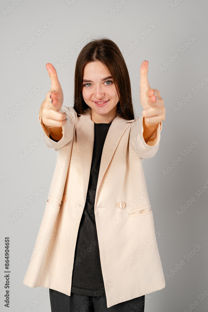 Young Woman Gesturing With Hands In Frame Against Plain Background Young Woman Gesturing With Hands In Frame Against Plain Background
