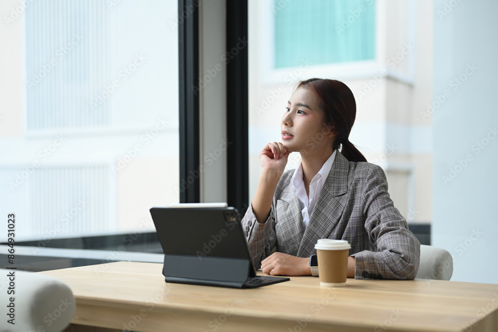Shot of an attractive businesswoman touching chin and looking away, thinking of question or idea Shot of an attractive businesswoman touching chin and looking away, thinking of question or idea