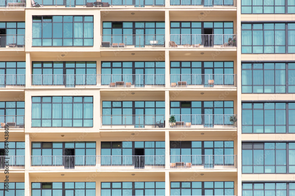 Multi-storey building with windows as background. Text Multi-storey building with windows as background. Text