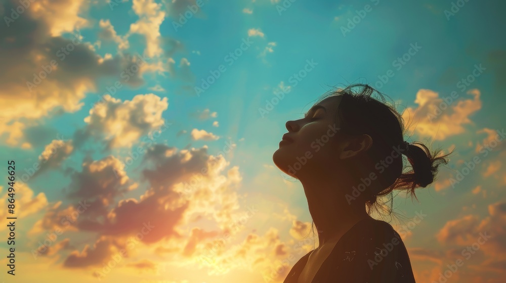 Silhouette of Attractive young woman looking up to the beautiful sky with feelings of hope and happiness Silhouette of Attractive young woman looking up to the beautiful sky with feelings of hope and happiness