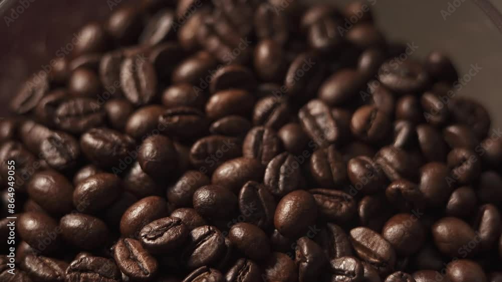 Roasted coffee beans in a coffee grinder close-up. Grinding of beans for making espresso Roasted coffee beans in a coffee grinder close-up. Grinding of beans for making espresso