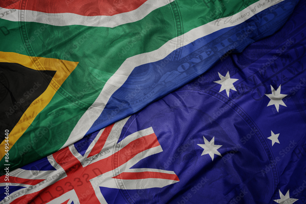 waving colorful flag of south africa and national flag of australia on the dollar money background. finance concept. waving colorful flag of south africa and national flag of australia on the dollar money background. finance concept.