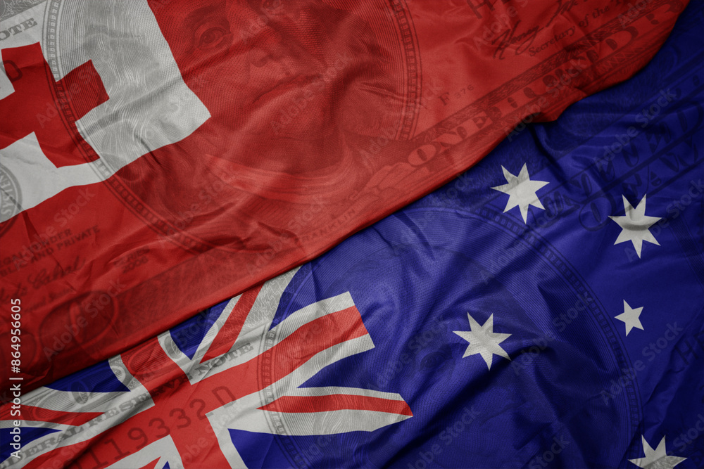 waving colorful flag of Tonga and national flag of australia on the dollar money background. finance concept. waving colorful flag of Tonga and national flag of australia on the dollar money background. finance concept.