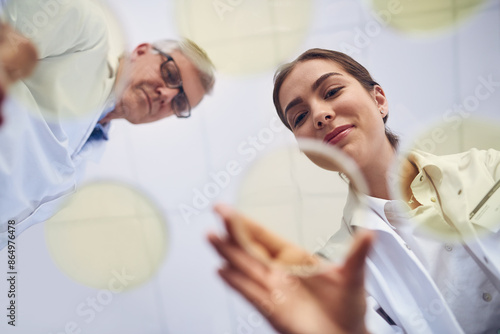 Фотография Breakthrough, science and teamwork with people in laboratory from below for innovation or research