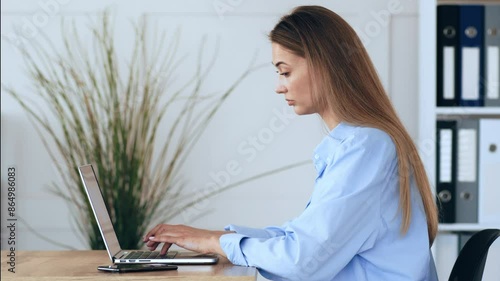 Work from home. Young woman typing plan on laptop computer, side view photo