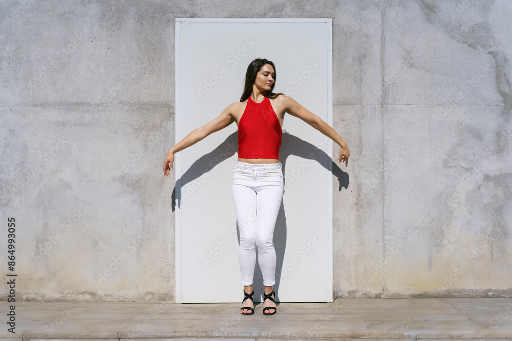 Young woman with arms outstretched dancing on sunny day Young woman with arms outstretched dancing on sunny day