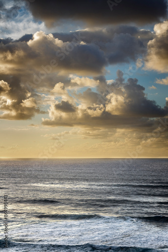 Seascape with large golden clouds at sunset. Tenerife, Spain.