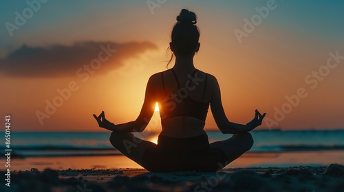 Peaceful sunset meditation on the beach. Silhouette of a woman in lotus pose against a vibrant sunset. Tranquility and mindfulness are the essence. Perfect for relaxation or wellness themes. AI