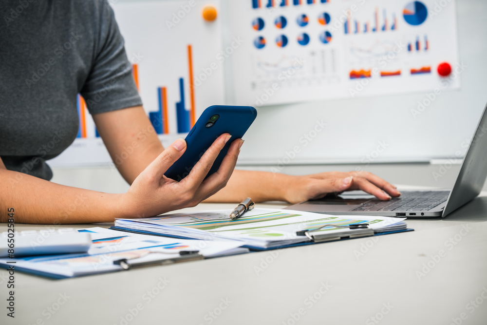 A businesswoman works diligently at her desk, reviewing financial documents and analyzing investment data. She ensures accuracy and efficiency in financial calculations and audit processes. A businesswoman works diligently at her desk, reviewing financial documents and analyzing investment data. She ensures accuracy and efficiency in financial calculations and audit processes.