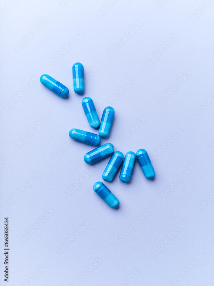 Amino acids capsules on bright paper background. Soft focus. Amino acids capsules on bright paper background. Soft focus.