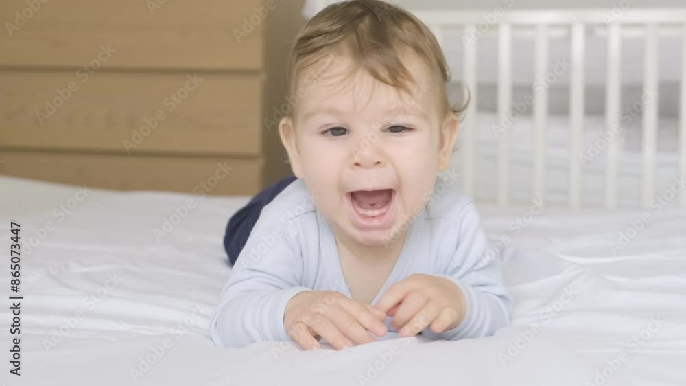 Adorable little baby boy crawling on her bed at home. Adorable little baby boy crawling on her bed at home.
