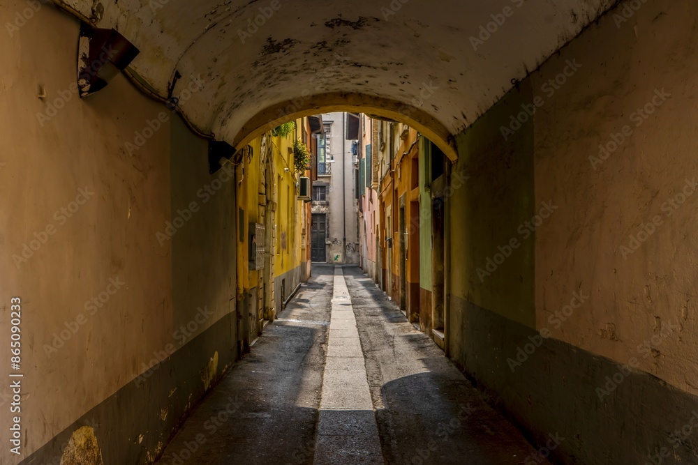 Old alley with yellow walls of tenement houses, old town of Italy Old alley with yellow walls of tenement houses, old town of Italy