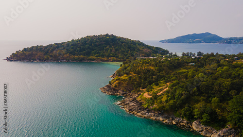 Paradise beach Phuket Patong. aerial top view amazing freedom beach small white sand beach with perfect nature. white wave hit the rock around island. green forest peaceful. green sea, landscape.