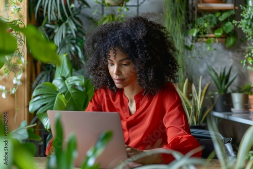 African American Woman Working Remotely Surrounded by Indoor Plants