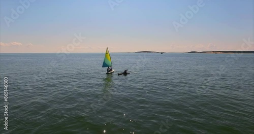 Small sailboat out on calm waters in the ocean at Cape Cod, Massachusetts, United States of America. photo