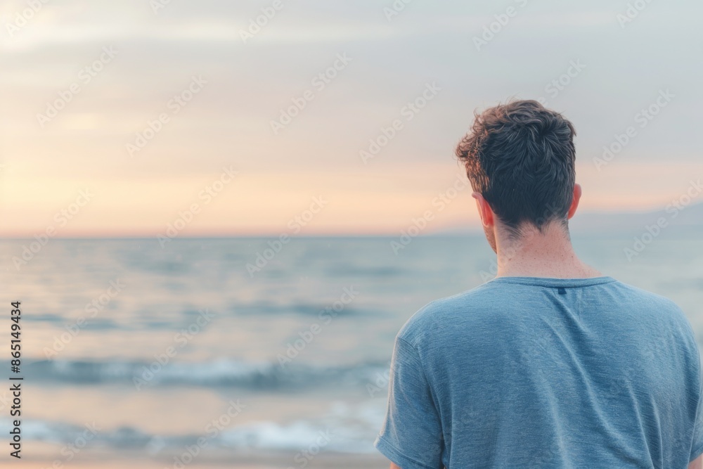 Serene Young Man Contemplating Ocean View at Sunset Serene Young Man Contemplating Ocean View at Sunset