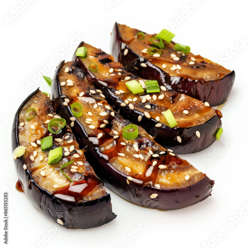 A serving of Japanese eggplant dengaku, grilled eggplant with sweet miso glaze, garnished with sesame seeds and green onions, isolated on white background. photo