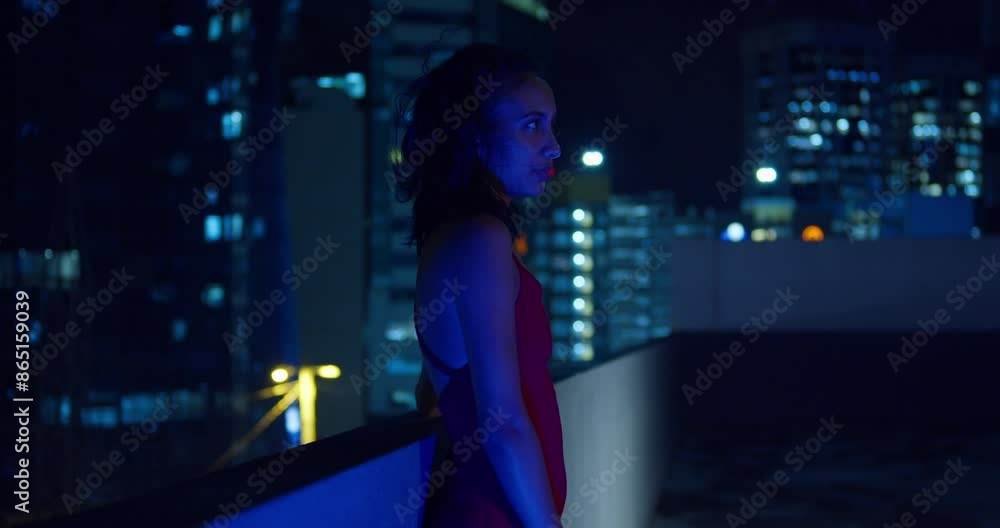 The Caribbean city lights of Port of Spain, Trinidad illuminate the background as a Hispanic girl stands on a rooftop. The Caribbean city lights of Port of Spain, Trinidad illuminate the background as a Hispanic girl stands on a rooftop.