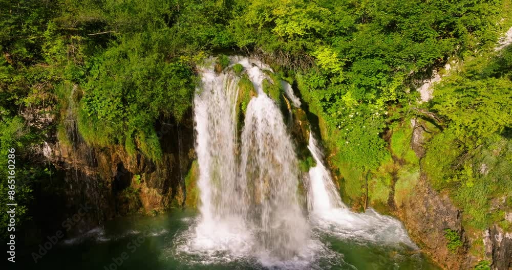 Scenic Galovac Waterfall Splashing Onto River In Plitvice Lakes National Park, Croatia. ascending drone shot Scenic Galovac Waterfall Splashing Onto River In Plitvice Lakes National Park, Croatia. ascending drone shot