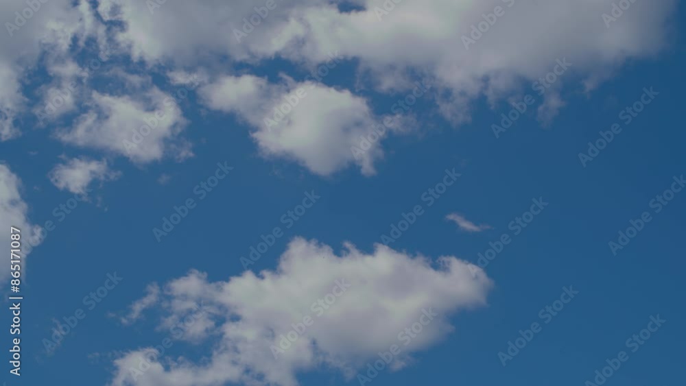 Time lapse. White cumulus clouds move across the blue sky. Time lapse. White cumulus clouds move across the blue sky.