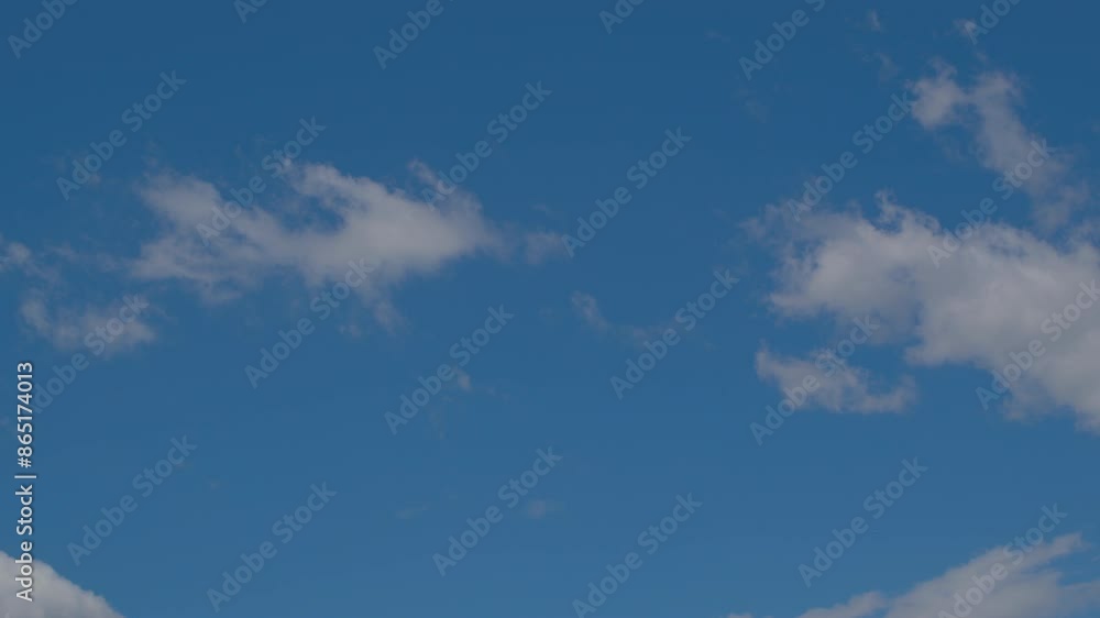 Time lapse. White cumulus clouds move across the blue sky. Time lapse. White cumulus clouds move across the blue sky.