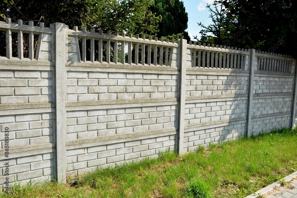 Fence made of decorative concrete fencing spans Fence made of decorative concrete fencing spans