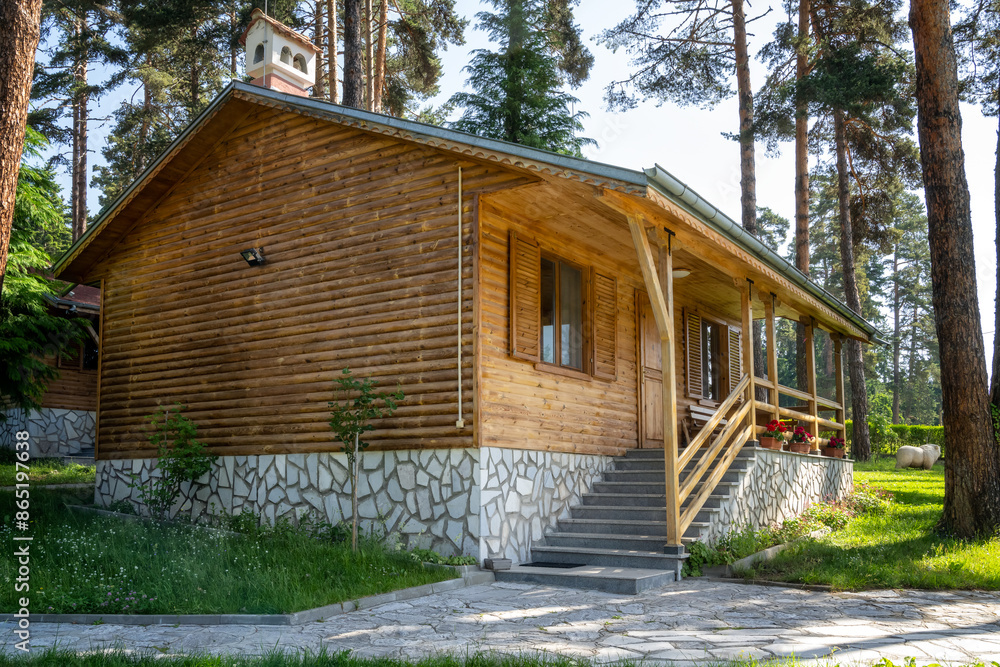 One-story wooden bungalows with a veranda in a beautiful mountain village among ancient trees near Bansko, Bulgaria One-story wooden bungalows with a veranda in a beautiful mountain village among ancient trees near Bansko, Bulgaria