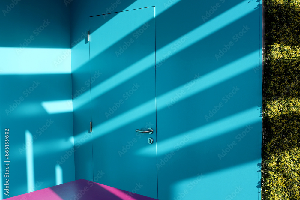 Light blue door with shadow on the wall. Modern interior in bright ...