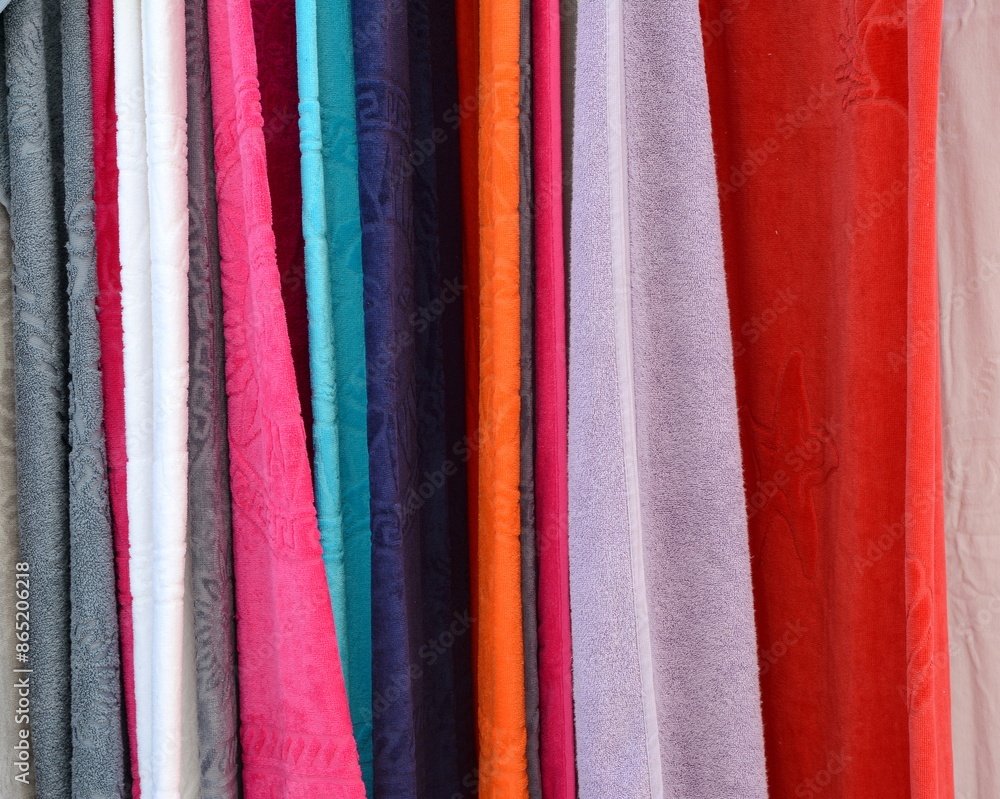 New clean bathrobes are hanging on hangers in the spa salon. Clean towels and aroma candles in the aromatherapy room. A shop selling towels and and bath robes. Exhibition of Cotton towels New clean bathrobes are hanging on hangers in the spa salon. Clean towels and aroma candles in the aromatherapy room. A shop selling towels and and bath robes. Exhibition of Cotton towels