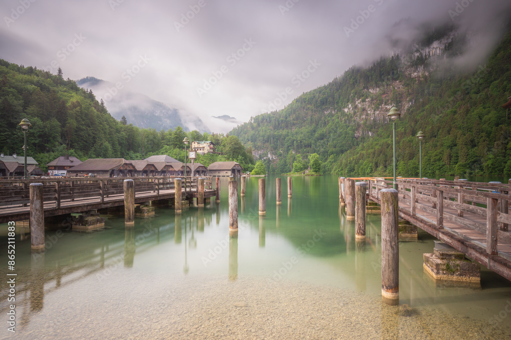 Tranquil lakeside dock with misty green mountains, peaceful and relaxation Tranquil lakeside dock with misty green mountains, peaceful and relaxation
