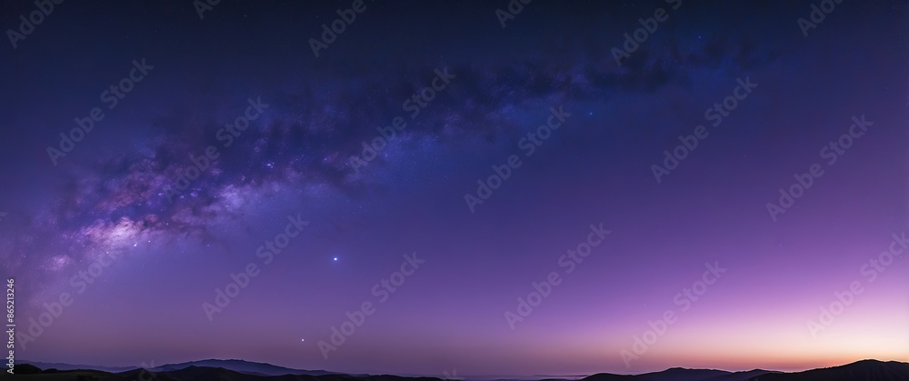 Fototapeta premium A breathtaking panoramic view of the Milky Way stretching across a twilight sky, blending hues of purple and blue, perfect for stargazing and tranquil retreats