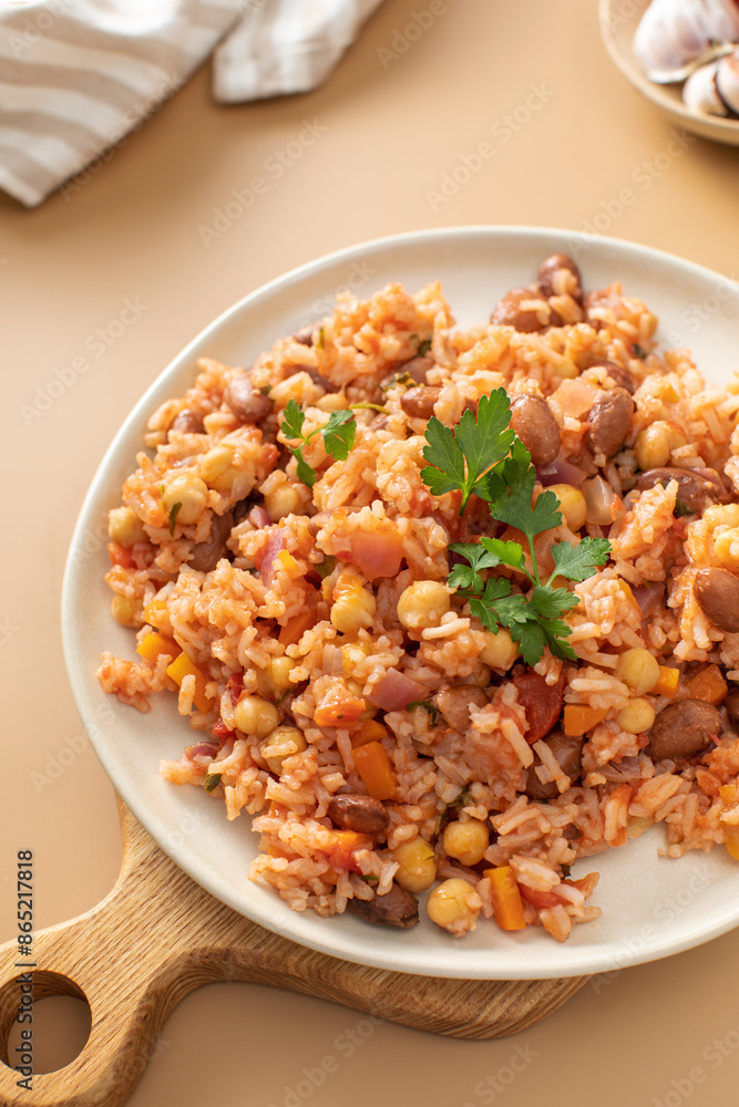 Jambalaya with rice chickpeas and kidney beans on beige table Jambalaya with rice chickpeas and kidney beans on beige table