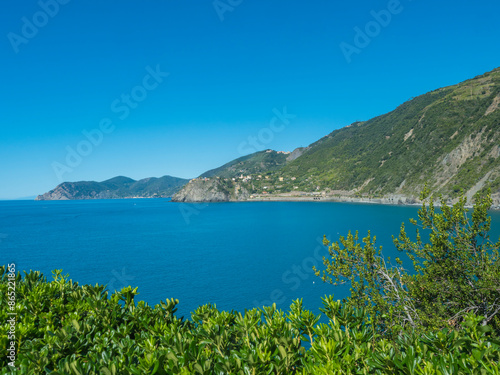 Coastline view from distance of the area Cinque Terre coast with Monterosso al Mare w and Corniglia Villages of National Park with ligurian sea and blue sky. La Spezia, Liguria, Beautiful mountain.