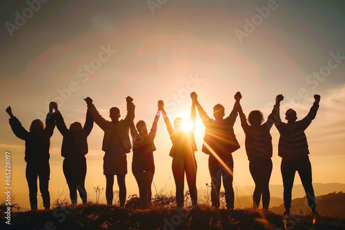 Silhouettes of friends standing in the field holding each other hands celebrating against a vibrant sunset. Generative AI.