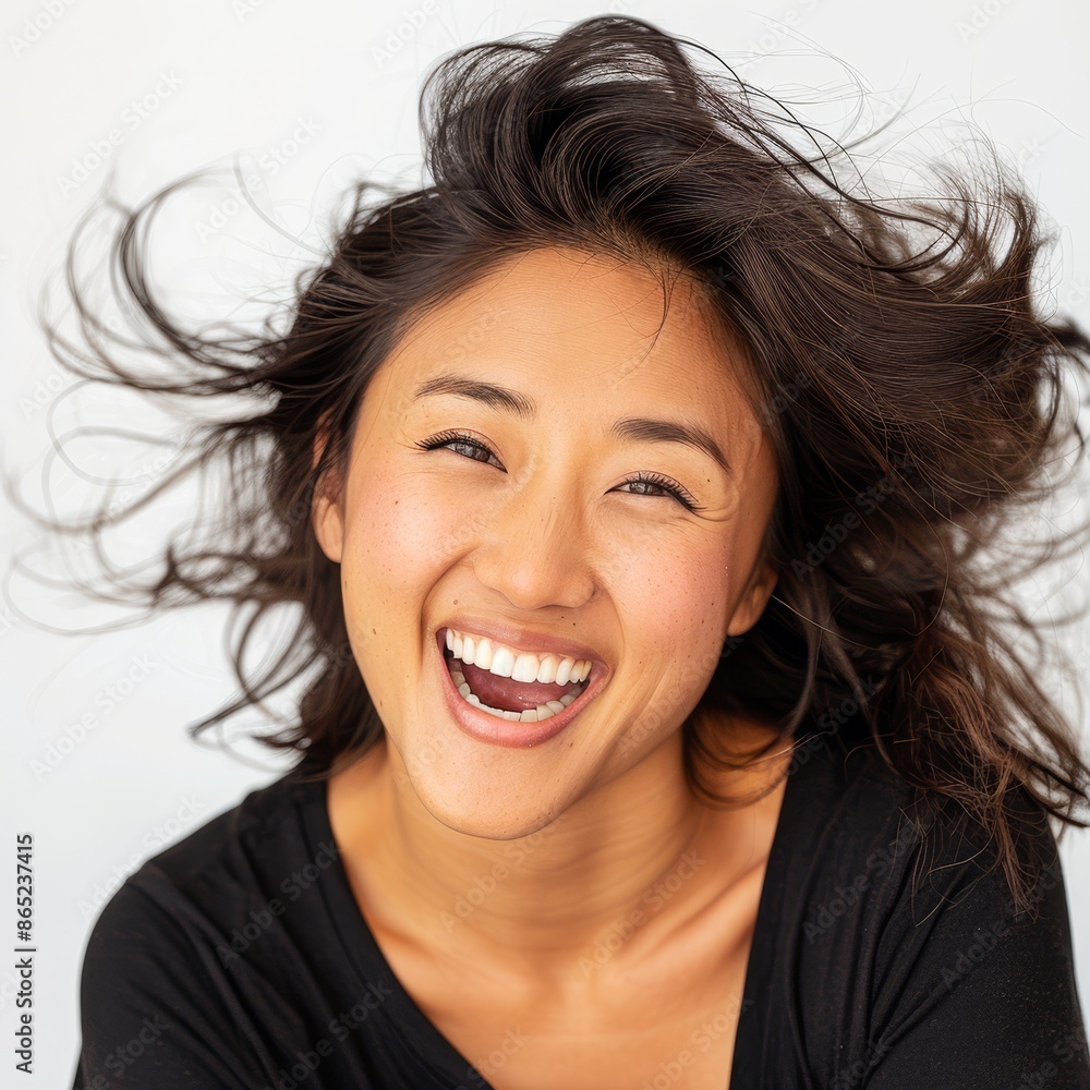 An Asian woman with her hair tossed back playfully, a bright smile lighting up her face, on a white background. An Asian woman with her hair tossed back playfully, a bright smile lighting up her face, on a white background.