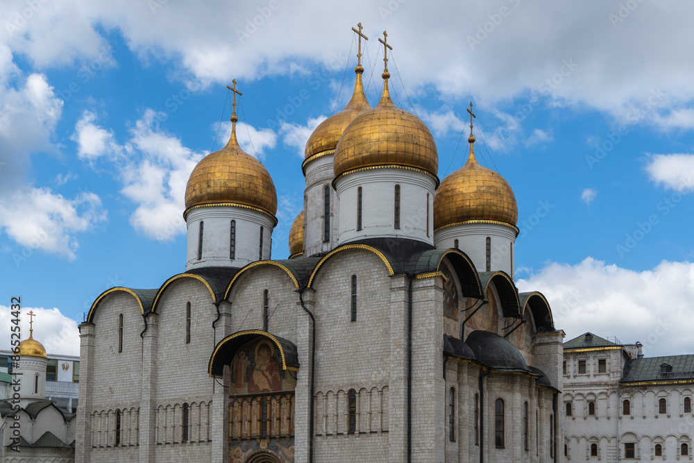 Snow-white Orthodox cathedrals are located on territory of Moscow Kremlin. The golden domes glow in sun against blue sky. Clear sunny summer day. Moscow, Russia – June 14, 2024 Snow-white Orthodox cathedrals are located on territory of Moscow Kremlin. The golden domes glow in sun against blue sky. Clear sunny summer day. Moscow, Russia – June 14, 2024