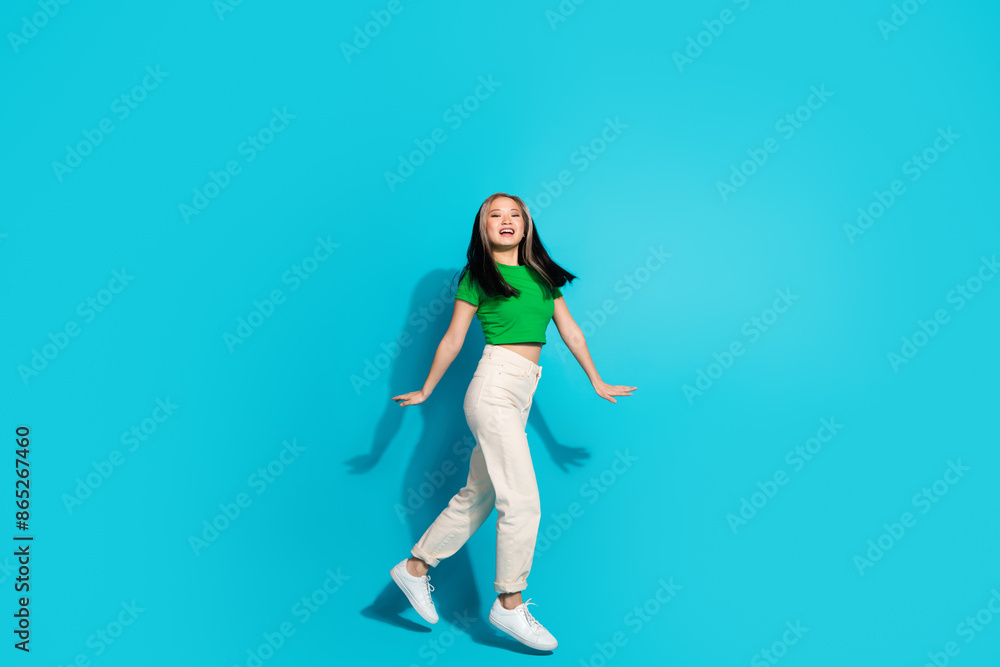 Full size profile photo of nice young girl jump empty space wear t-shirt isolated on teal color background Full size profile photo of nice young girl jump empty space wear t-shirt isolated on teal color background
