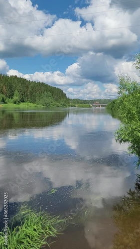 Rural landscape with river and clouds in summer. Vertical video.