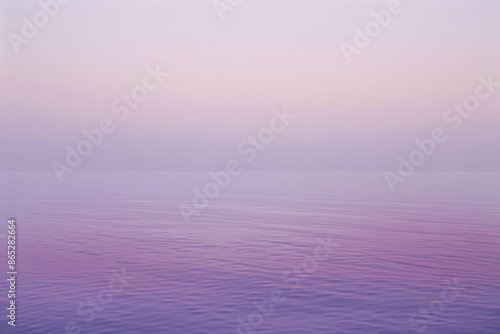 Calm water reflects a hazy purple sky, creating a peaceful scene perfect for relaxation and contemplation outdoors. Soft pastel hues blend in a tranquil gradient, capturing nature's serene beauty