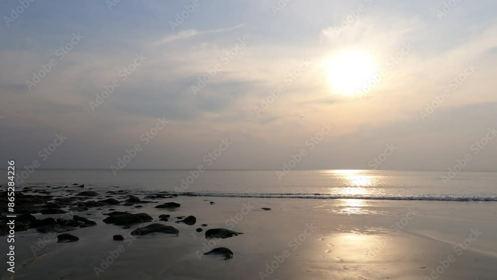 The slow waves lash the seashore during the sunset. Beach vibes. The slow waves lash the seashore during the sunset. Beach vibes.