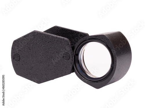 Miniature magnifying glass in a metal case, open lying on a plane, isolated on a white background