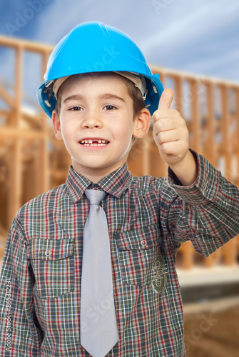 Young arhitect with helmet.showing thumb up photo