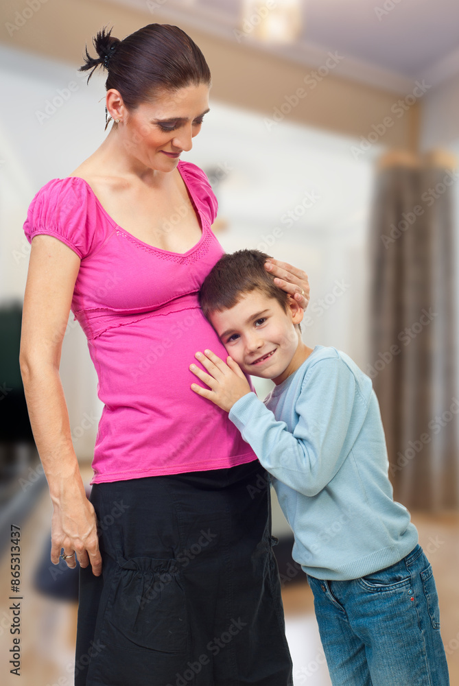 Fototapeta premium Child Listens to Pregnant Mother's Belly