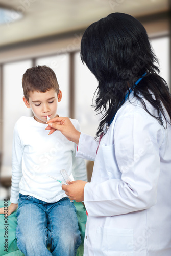 Pediatrician Measures Child's Temperature