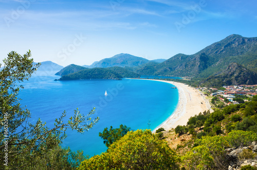 Aerial view of Ölüdeniz Beach, Turkey. Turquoise waters, sandy shoreline and lush green mountains. Oludeniz is beach resort on Turkish Riviera, at conjunction point of Aegean and Mediterranean seas  photo