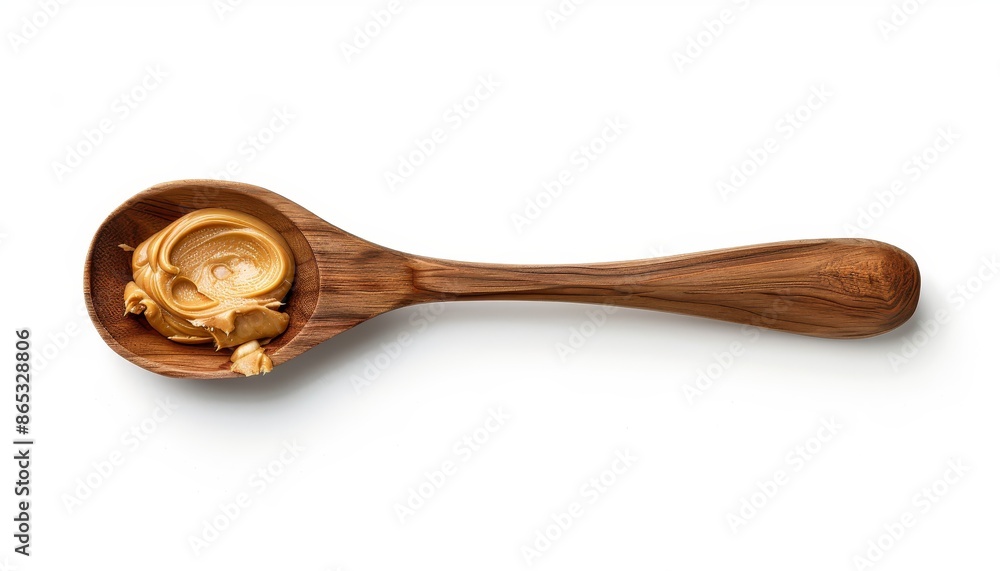 Top down view of a peanut butter covered wooden spoon isolated on a white background Top down view of a peanut butter covered wooden spoon isolated on a white background